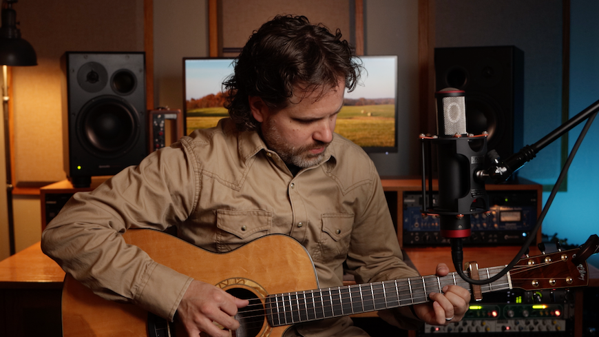 Joshua Williams playing guitar in studio